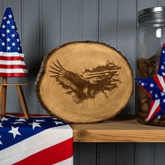Round wood with bark that has an eagle in front of an American Flag engraved, with flag decorations