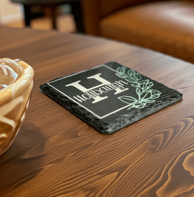 Personalized slate coaster sitting on a coffee table