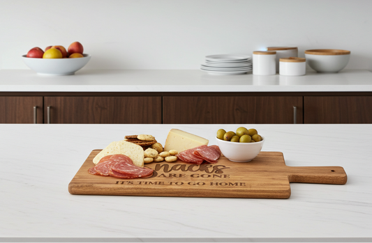 Wooden cutting charcuterie board with food on a kitchen counter, featuring text if you can read this the snacks are gone it's time to go home