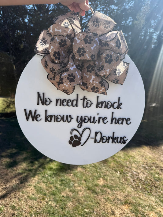 Decorative sign with a paw print design and text on a white background