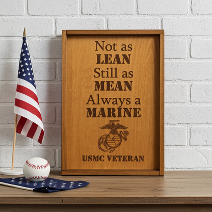 Wooden laser engraved framed sign with USMC Veteran quote on a table with American flag and baseball