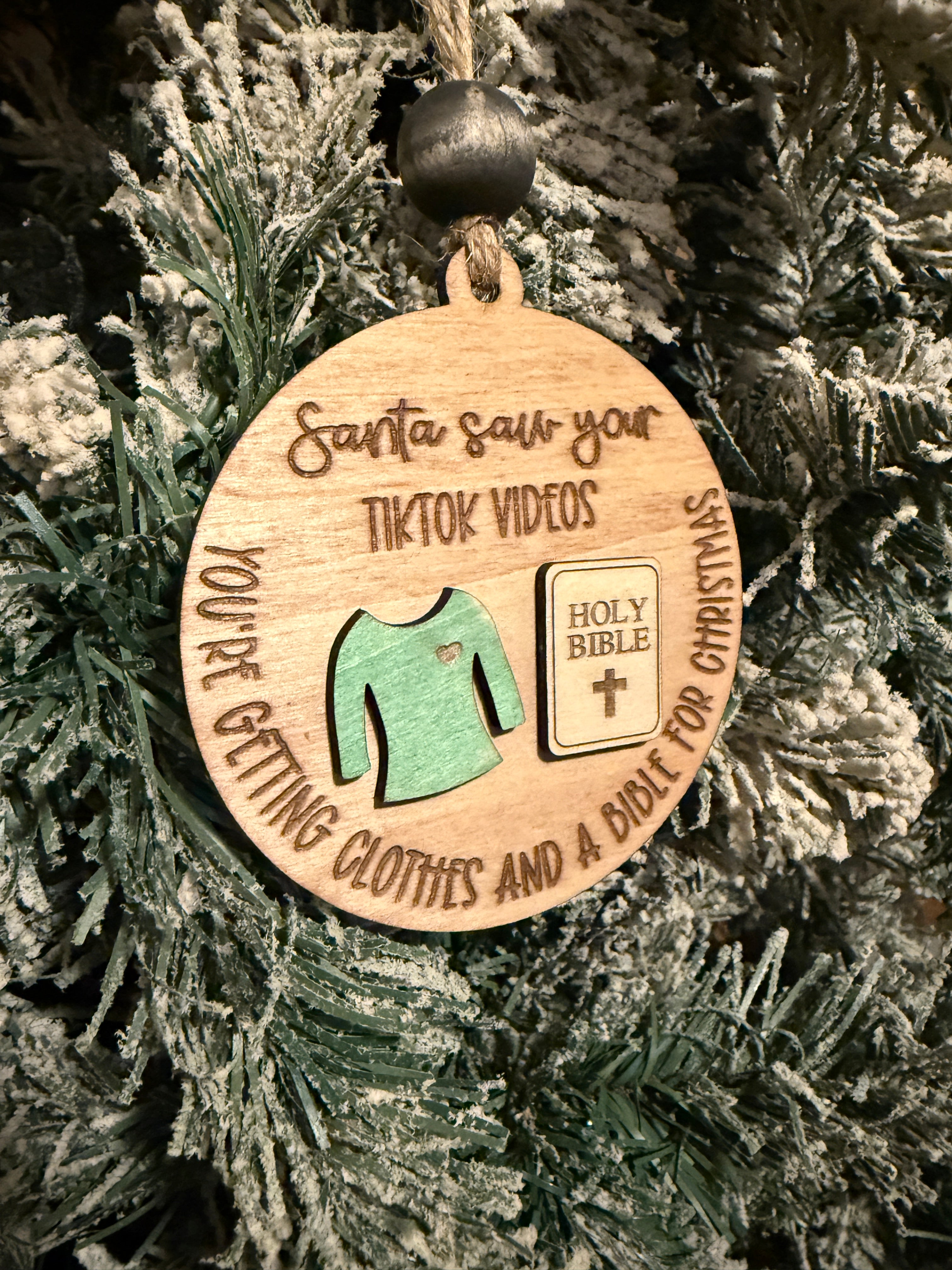 Wooden ornament with text and icons on a Christmas tree