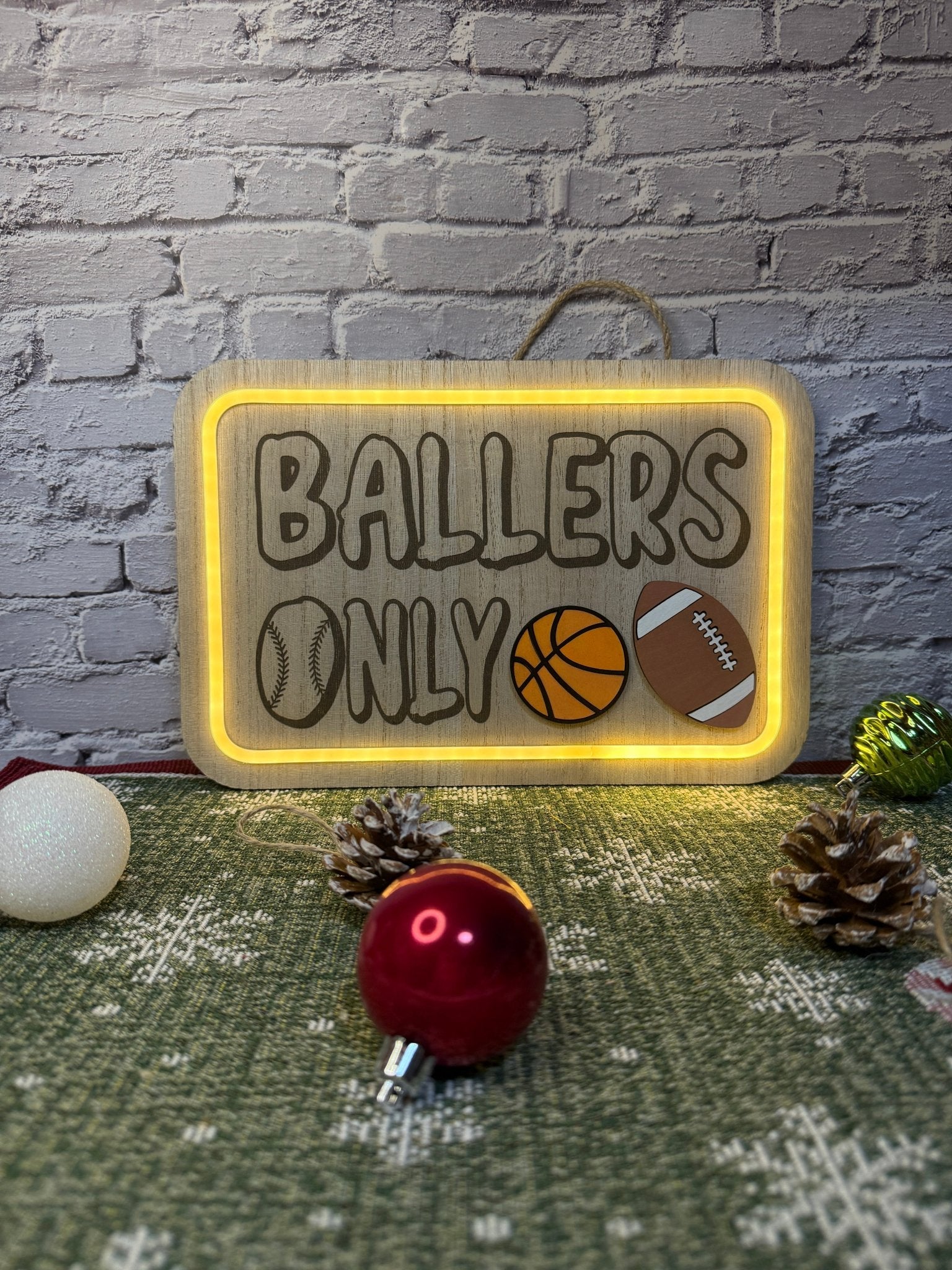 Lighted bedroom sign laser engraved with text ballers only and laser cut sports balls with light on