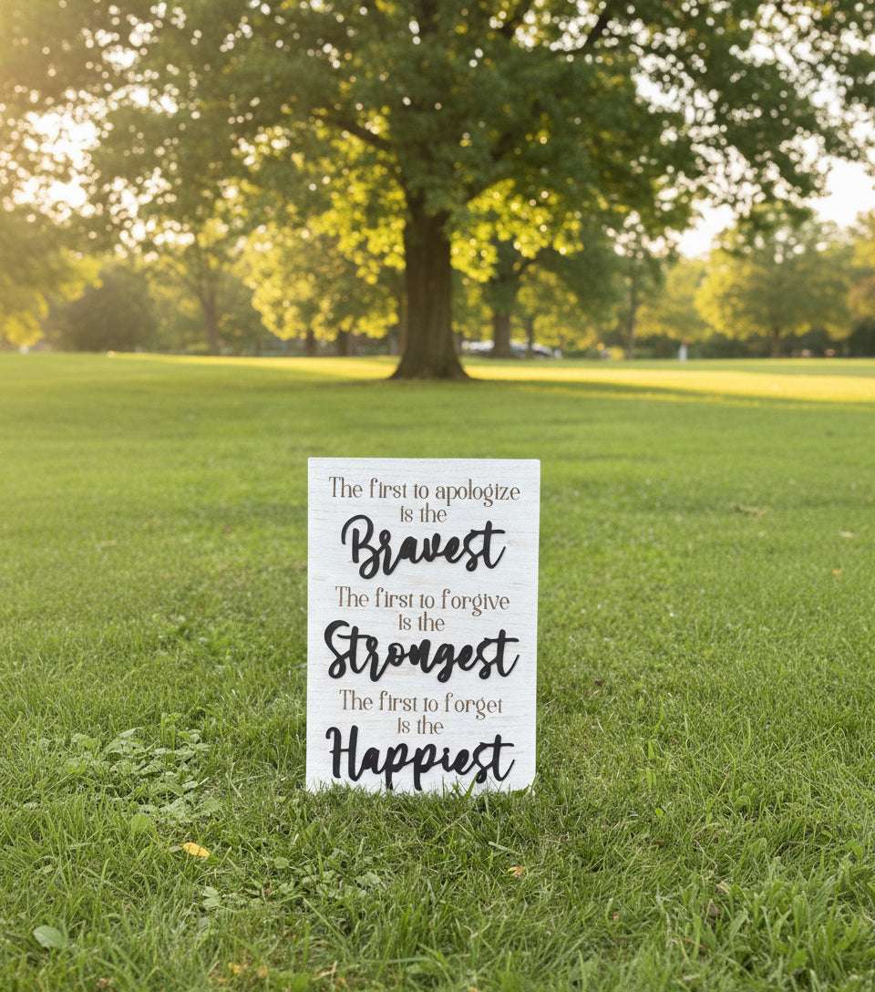 Wooden sign with motivational quote on grass